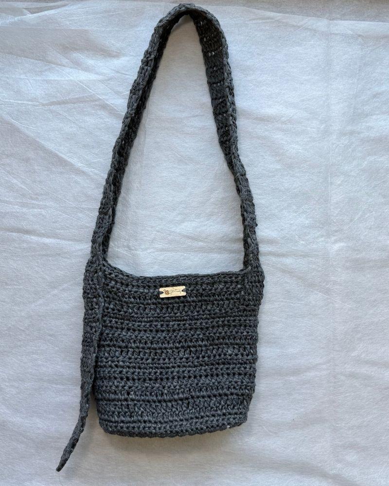A chic crocheted bag indoors, Gray