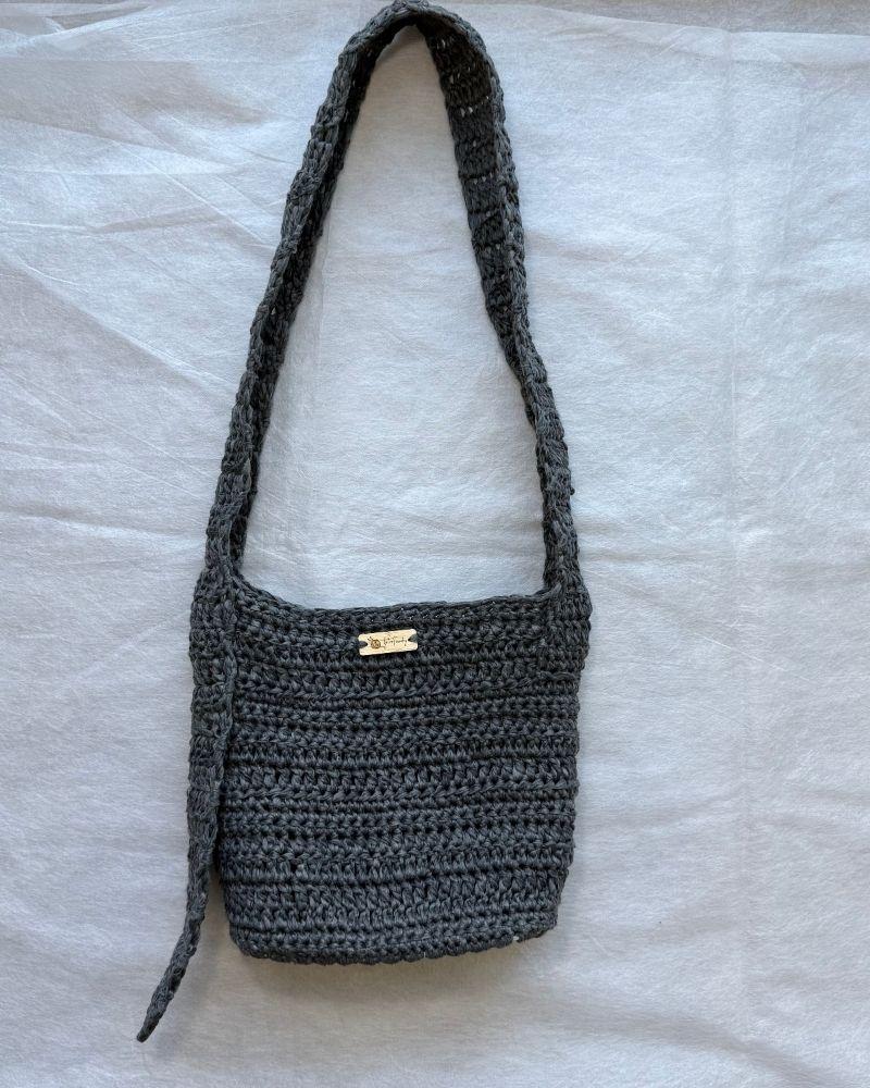 A chic crocheted bag indoors, Gray