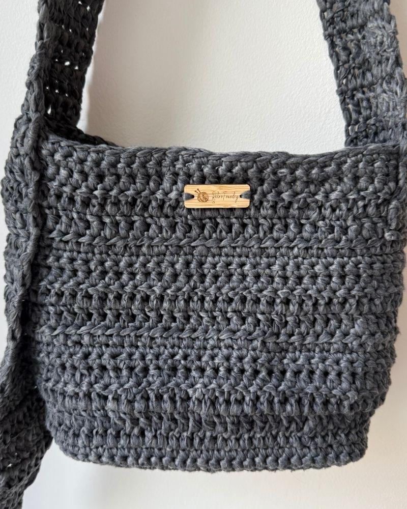 a chic crocheted bag indoors, Gray