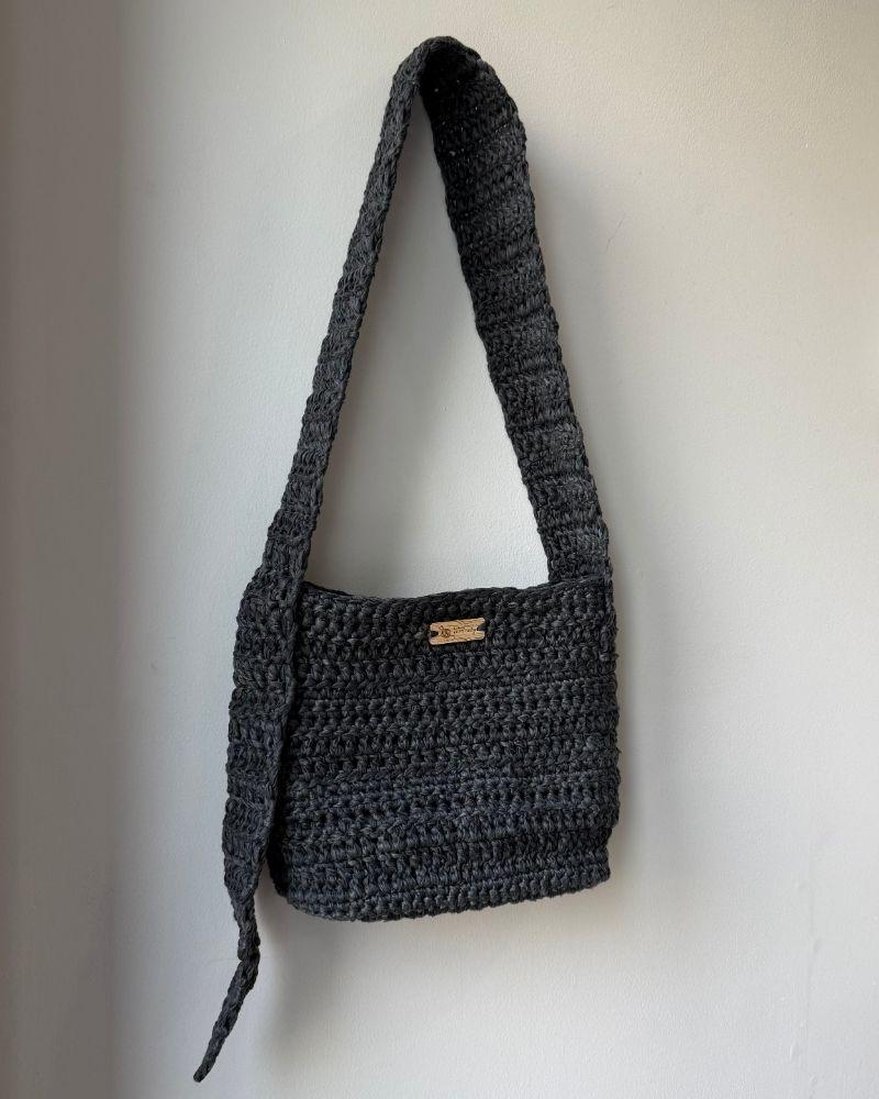 A chic crocheted bag indoors, Gray