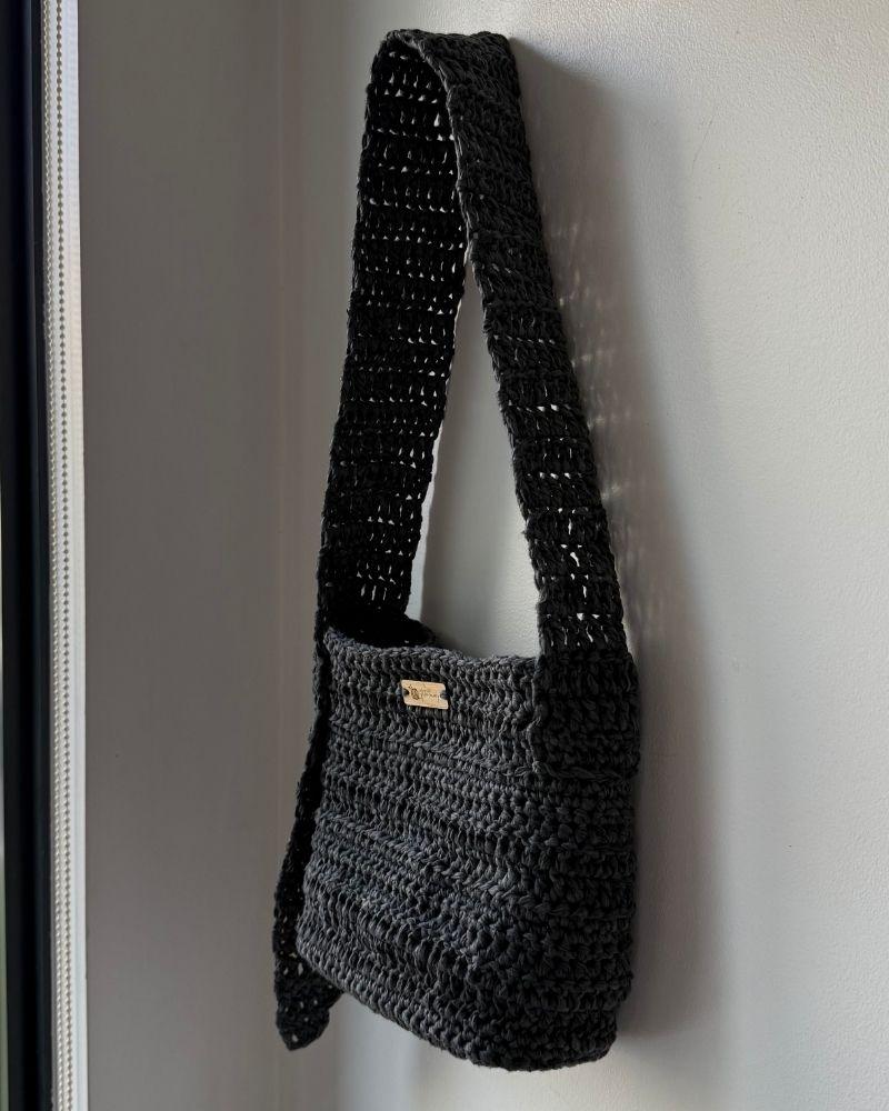 A chic crocheted bag indoors, Gray