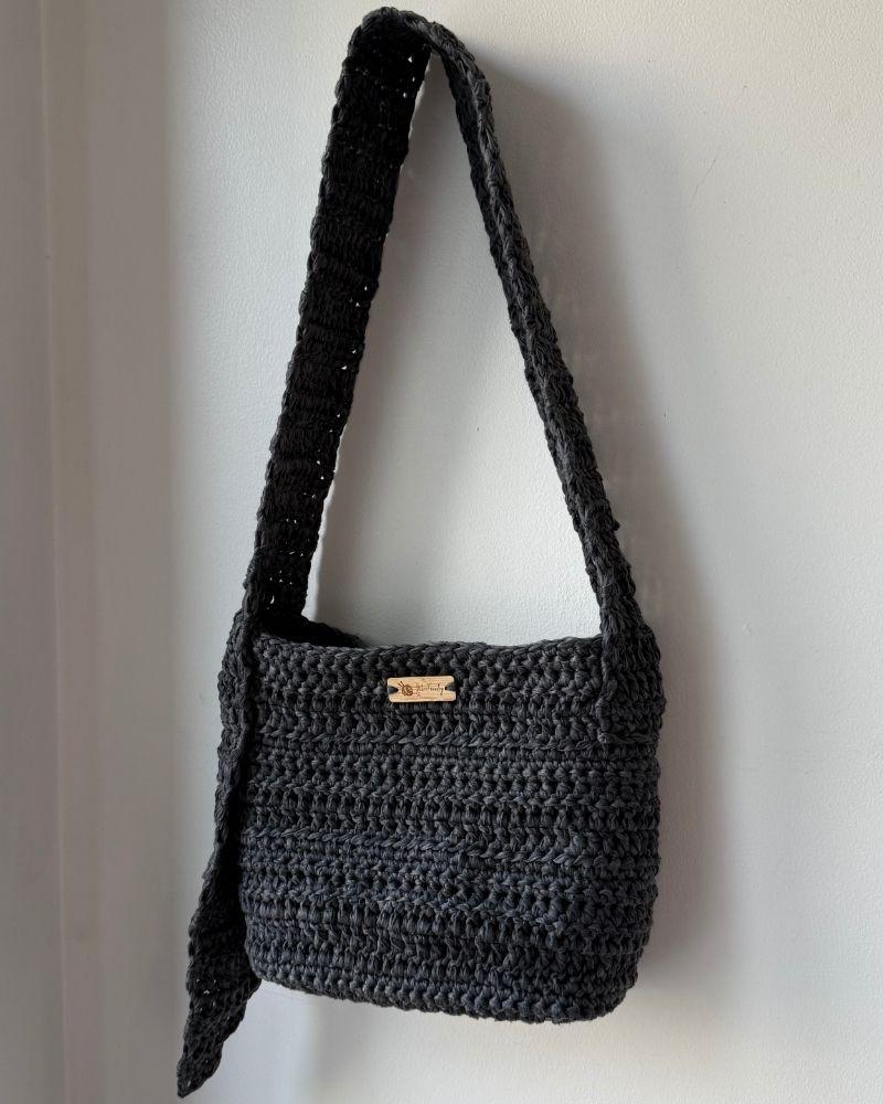 A chic crocheted bag indoors, Gray
