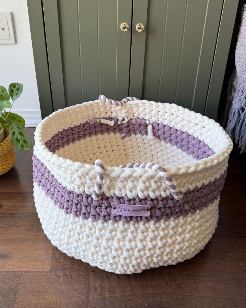White woven basket on a wooden floor next to a green cabinet, Berry Off White