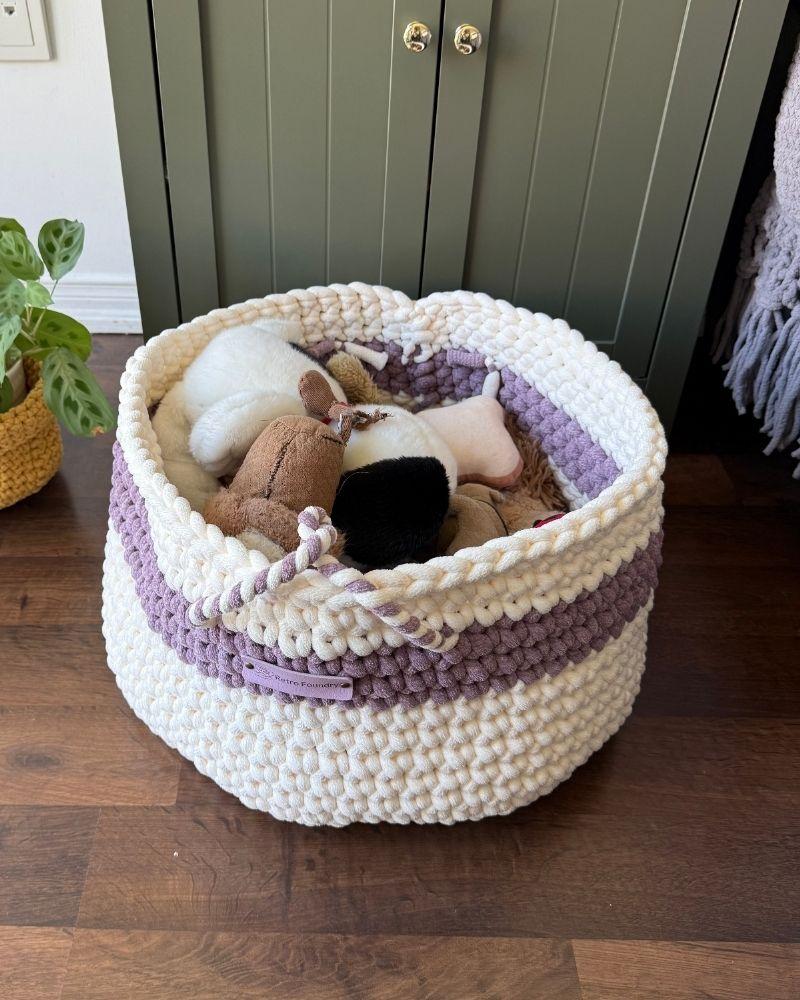 White woven basket on a wooden floor next to a green cabinet, Berry Off White