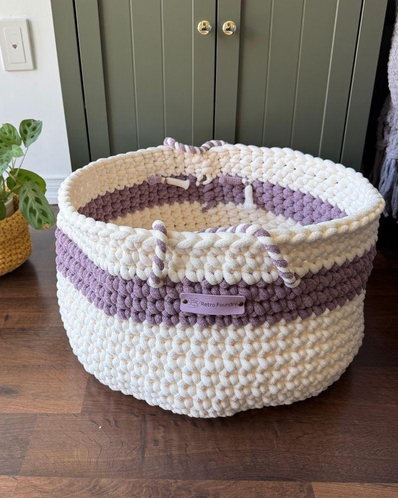 White woven basket on a wooden floor next to a green cabinet, Berry Off White