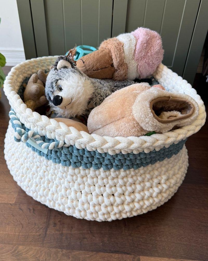 White woven basket on a wooden floor next to a green cabinet, Teal Off White