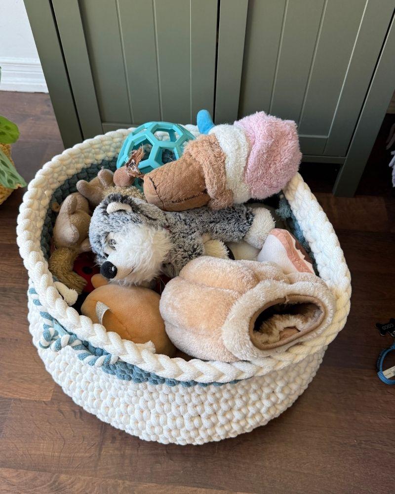 White woven basket on a wooden floor next to a green cabinet, Teal Off White