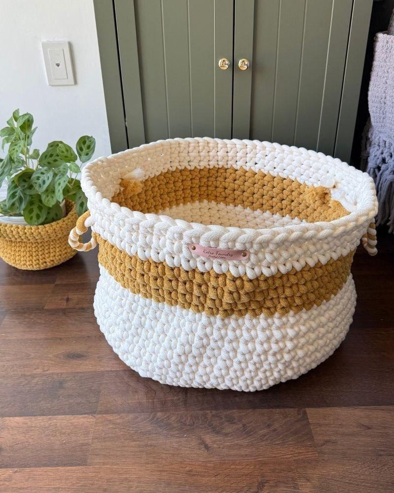 White woven basket on a wooden floor next to a green cabinet, Gold Off White