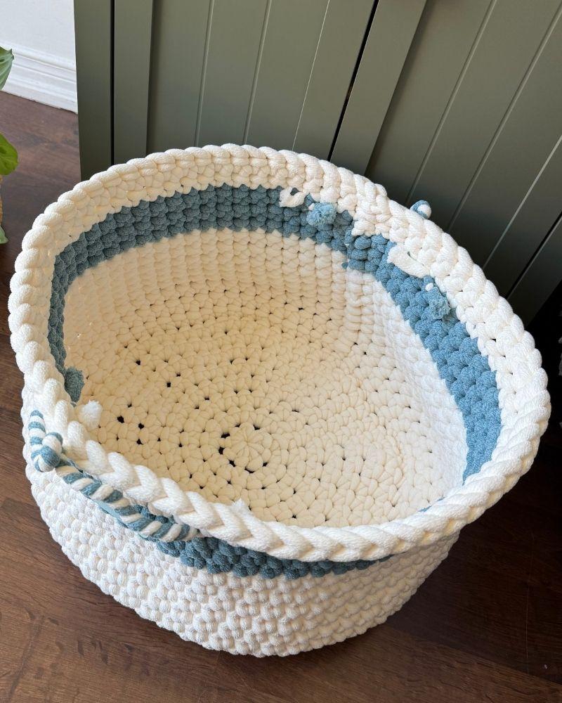White woven basket on a wooden floor next to a green cabinet, Teal Off White