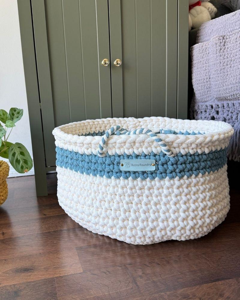 White woven basket on a wooden floor next to a green cabinet, Teal Off White