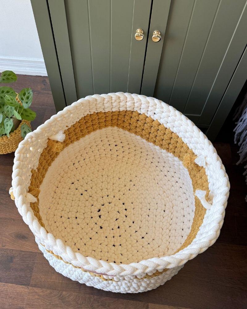 White woven basket on a wooden floor next to a green cabinet, Gold Off White